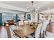Elegant dining room with wood table and seating, connected to both the living room and kitchen at 3724 Fawn Grove Ct, Land O Lakes, FL 34639