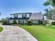 Attractive exterior featuring manicured shrubs, flower boxes, and dark shutters on a sunny day at 3724 Fawn Grove Ct, Land O Lakes, FL 34639