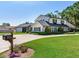 Charming exterior view of a well-maintained home with mature landscaping and a mailbox at 3724 Fawn Grove Ct, Land O Lakes, FL 34639