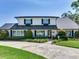 Beautiful two-story home with white siding, black shutters, and front yard landscaping at 3724 Fawn Grove Ct, Land O Lakes, FL 34639