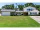 Two-story home features a well-manicured lawn, basketball hoop, and attached garage at 3724 Fawn Grove Ct, Land O Lakes, FL 34639