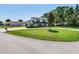 Lush front yard with circular driveway and mature landscaping showcases the lovely home at 3724 Fawn Grove Ct, Land O Lakes, FL 34639
