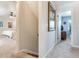 Bright hallway leading to multiple rooms, with neutral walls, leading to bedroom with ceiling fan and natural light at 3724 Fawn Grove Ct, Land O Lakes, FL 34639