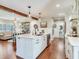 Kitchen with marble countertops and backsplash, stainless steel dishwasher and a view of the adjacent living area at 3724 Fawn Grove Ct, Land O Lakes, FL 34639