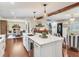 Open concept kitchen features a center island with marble countertops and open sightlines to other living spaces at 3724 Fawn Grove Ct, Land O Lakes, FL 34639