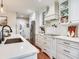 The kitchen offers white cabinetry, countertops, and fixtures, with stainless appliances and a sink in the island at 3724 Fawn Grove Ct, Land O Lakes, FL 34639