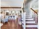 Open-concept living space with hardwood floors, wooden beams, staircase, and kitchen view at 3724 Fawn Grove Ct, Land O Lakes, FL 34639