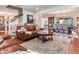 Living room features hardwood floors, a fireplace, a staircase and an open concept view to the dining area at 3724 Fawn Grove Ct, Land O Lakes, FL 34639