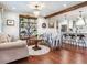 Bright living room with hardwood floors, stylish decor, chandelier, and kitchen access at 3724 Fawn Grove Ct, Land O Lakes, FL 34639