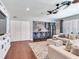 Open-concept living room featuring a wet bar with brick, seamless integration to the kitchen, and bright, natural lighting at 3724 Fawn Grove Ct, Land O Lakes, FL 34639