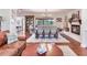 Open-concept living area features a dining area, fireplace, and plenty of natural light from the large windows at 3724 Fawn Grove Ct, Land O Lakes, FL 34639