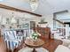 Open-concept living area with hardwood flooring, a chandelier, and a partial view of the kitchen at 3724 Fawn Grove Ct, Land O Lakes, FL 34639