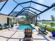 An in-ground pool is screened in and surrounded by chairs and blue potted plants at 3724 Fawn Grove Ct, Land O Lakes, FL 34639