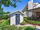 Charming shed with oval window door surrounded by lush landscaping in a well-maintained backyard setting at 3724 Fawn Grove Ct, Land O Lakes, FL 34639