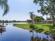 A waterfront backyard features lush landscaping and a serene lake view at 3724 Fawn Grove Ct, Land O Lakes, FL 34639