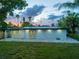 A view of the home's backyard featuring a brick patio, lush lawn and well-maintained landscaping at 3947 Overlook Ne Dr, St Petersburg, FL 33703
