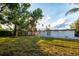 Spacious backyard featuring a well-maintained lawn, privacy fence, and a charming white house with double doors at 3947 Overlook Ne Dr, St Petersburg, FL 33703