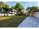Expansive backyard featuring a large lawn, patio, and mature trees providing ample shade and privacy at 3947 Overlook Ne Dr, St Petersburg, FL 33703