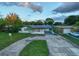 Inviting exterior view of home with circular driveway and covered parking at 3947 Overlook Ne Dr, St Petersburg, FL 33703