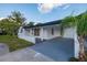 Charming single-story home with a well-manicured lawn and covered parking at 3947 Overlook Ne Dr, St Petersburg, FL 33703