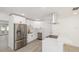 Modern kitchen with white cabinets, stainless steel appliances, and quartz countertops at 3947 Overlook Ne Dr, St Petersburg, FL 33703
