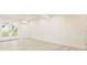 Inviting living area features light wood floors, bright white walls, and glass doors leading to the outdoors at 3947 Overlook Ne Dr, St Petersburg, FL 33703