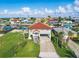 Stunning aerial view of a waterfront property with well-maintained landscaping, a private driveway, and neighboring houses at 4137 Des Prez Ct, Hernando Beach, FL 34607