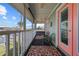 Covered balcony with seating and a scenic view of the waterfront and neighboring homes at 4137 Des Prez Ct, Hernando Beach, FL 34607