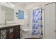 Well-lit bathroom with a shower and tub combination, updated vanity, and blue-themed decorations at 4137 Des Prez Ct, Hernando Beach, FL 34607