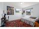 Bedroom decorated with superhero posters, TV and large window, featuring bright patterned floor rug at 4137 Des Prez Ct, Hernando Beach, FL 34607