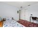 Comfortable bedroom featuring a bed with patterned bedding, a desk, and a double closet at 4137 Des Prez Ct, Hernando Beach, FL 34607