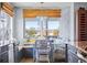 Bright breakfast nook with bench seating, large windows, and lovely chandelier at 4137 Des Prez Ct, Hernando Beach, FL 34607