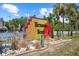 Entrance to Hernando Beach with a colorful sign, palm trees, and a unique bird sculpture at 4137 Des Prez Ct, Hernando Beach, FL 34607