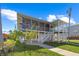 Attractive multi-story house featuring a porch, balcony, well-manicured lawn, and complemented by blooming trees at 4137 Des Prez Ct, Hernando Beach, FL 34607