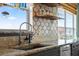 Kitchen sink area features granite countertops, updated faucet, and decorative backsplash at 4137 Des Prez Ct, Hernando Beach, FL 34607
