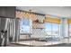 Bright kitchen boasts stainless steel appliances, granite counters, and unique fish scale tile backsplash at 4137 Des Prez Ct, Hernando Beach, FL 34607