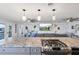 Open concept living space featuring a breakfast bar, gas range and scenic water views at 4137 Des Prez Ct, Hernando Beach, FL 34607