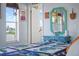 Comfortable bedroom featuring a turquoise vanity area, a window and nautical decor at 4137 Des Prez Ct, Hernando Beach, FL 34607