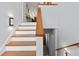 Elegant staircase with wooden banister and modern lighting, creating a stylish transition at 4137 Des Prez Ct, Hernando Beach, FL 34607