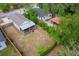 Aerial view of a backyard with a patio, surrounded by mature trees and vegetation on a sunny day at 4218 E Cayuga St, Tampa, FL 33610