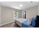 Bright bedroom featuring a large window and comfortable bed with blue covers at 4218 E Cayuga St, Tampa, FL 33610
