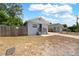 Quaint single-story home with fenced yard, driveway, and neighboring house under a partly cloudy sky at 4218 E Cayuga St, Tampa, FL 33610