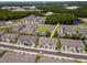 Community aerial view featuring townhouse with attached garages and shared community amenities, including pool at 4262 Cloud Hopper Way, Lutz, FL 33559