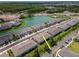 Community aerial view featuring townhouses, community lake, and lush surroundings at 4262 Cloud Hopper Way, Lutz, FL 33559