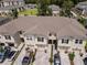 Aerial view of townhomes with one-car garages, and nicely maintained landscaping at 4262 Cloud Hopper Way, Lutz, FL 33559