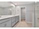 Bathroom features dual sinks, a large mirror, and a glass-enclosed shower at 4262 Cloud Hopper Way, Lutz, FL 33559