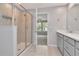 Bathroom with glass-enclosed shower and gray vanity with sink at 4262 Cloud Hopper Way, Lutz, FL 33559