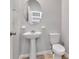 Elegant half bathroom with a pedestal sink, an oval mirror, and neutral wall paint at 4262 Cloud Hopper Way, Lutz, FL 33559
