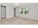 Bright bedroom with carpet, a ceiling light fixture, and windows with natural light at 4262 Cloud Hopper Way, Lutz, FL 33559