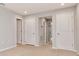 Bright and airy bedroom with neutral walls, multiple doors and plush carpeting at 4262 Cloud Hopper Way, Lutz, FL 33559